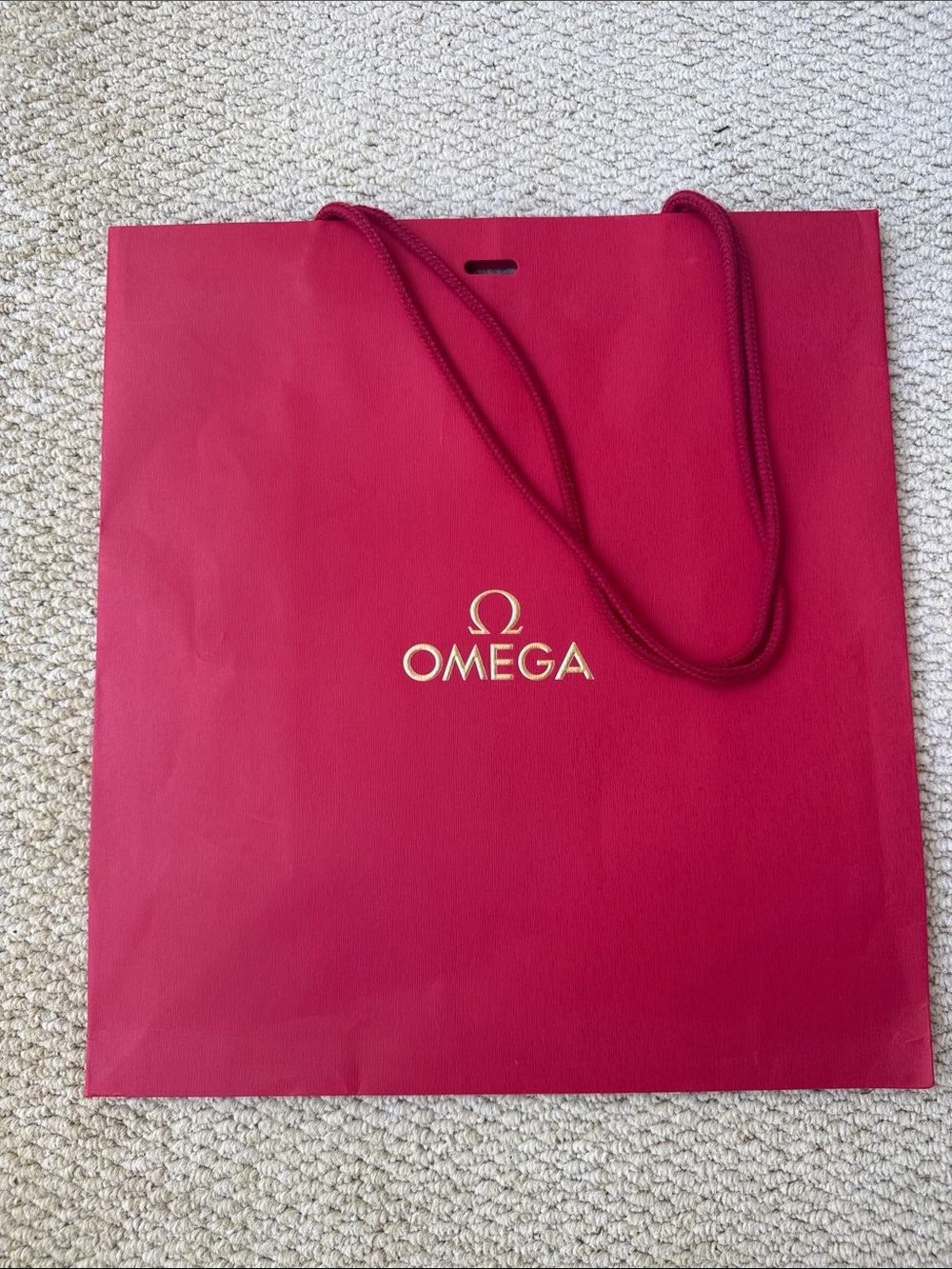 Omega red paper shopping bag